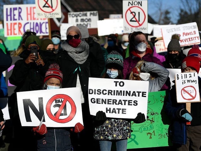 People protest against Quebec's Bill 21 secularism legislation in Chelsea, Que., on Dec. 14, 2021.