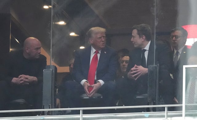 From left, Dana White, President Donald Trump, Elon Musk and House Speaker Mike Johnson, R-La., talk at a memorial for Charlie Kirk, Sunday at State Farm Stadium in Glendale, Ariz.