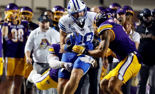 BYU tight end Carsen Ryan, front left, prepares to be hit by East Carolina's Teagan Wilk, front right, was called for targeting and ejected during the first half of an NCAA college football game in Greenville, N.C., Saturday, Sept. 20, 2025.