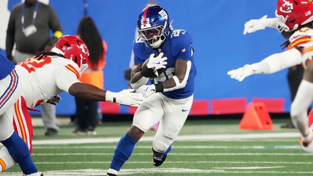 Sep 21, 2025; East Rutherford, New Jersey, USA; New York Giants running back Tyrone Tracy Jr. (29) runs against Kansas City Chiefs linebacker Nick Bolton (32) in the first quarter at MetLife Stadium. Mandatory Credit: Robert Deutsch-Imagn Images