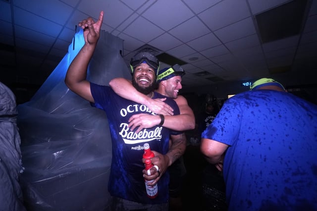KANSAS CITY, MISSOURI - SEPTEMBER 21: Vladimir Guerrero Jr. #27 and George Springer #4 of the Toronto Blue Jays celebrate after clinching a playoff berth at Kauffman Stadium on September 21, 2025 in Kansas City, Missouri.