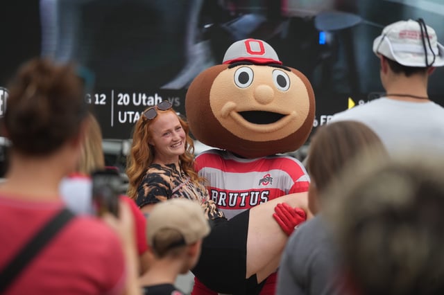 Brutus holds a woman during pregame activities outside Ohio Stadium prior to the Ohio State Ohio football game Saturday, Sept. 13, 2025.