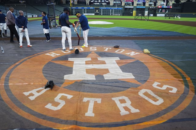Houston Astros Isaac Paredes, center, visits with Taylor Trammell before a MLB baseball game in Houston, Sunday, Sept. 21, 2025.