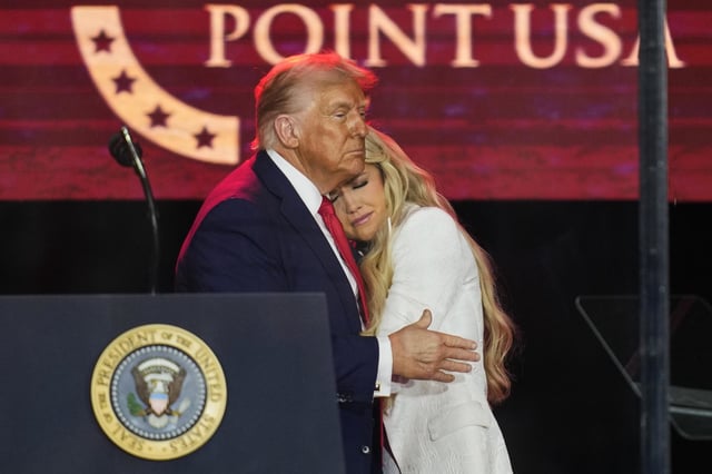 Trump embraces Erika Kirk at the memorial.