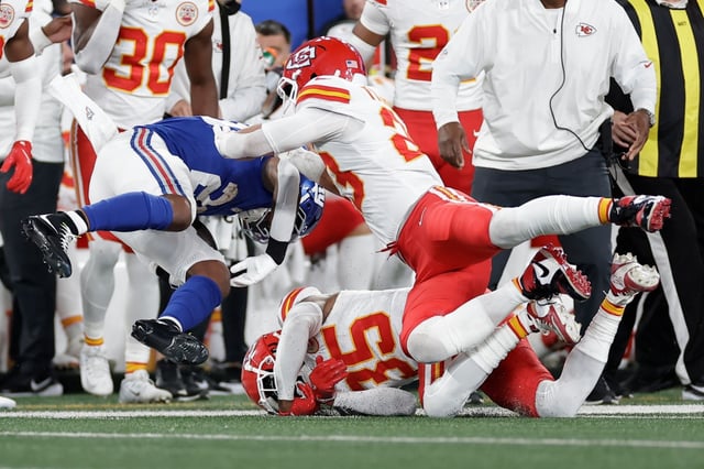 New York Giants running back Tyrone Tracy Jr., left, is injured on a play as Kansas City Chiefs cornerback Jaylen Watson (35) and linebacker Drue Tranquill, right, defend during the first half of an NFL football game Sunday, Sept. 21, 2025, in East Rutherford, N.J. (AP Photo/Adam Hunger)
