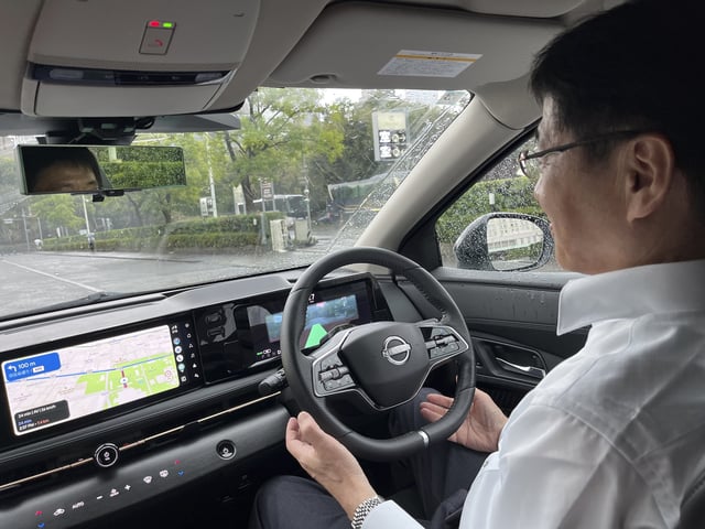 Nissan manager Tetsuya Iijima demonstrates the automaker’s self-driving technology, showing he isn’t using his hands on Sept. 11, 2025 in Tokyo. (AP Photo/Yuri Kageyama)