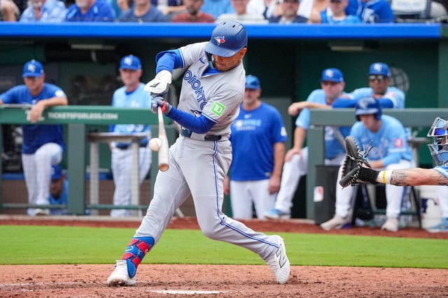 Sep 21, 2025; Kansas City, Missouri, USA; Toronto Blue Jays shortstop Andres Gimenez (0) hits a one run triple against the Kansas City Royals during the eighth inning at Kauffman Stadium. Mandatory Credit: Denny Medley-Imagn Images