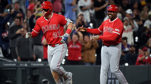 Sep 20, 2025; Denver, Colorado, USA; Los Angeles Angels designated hitter Mike Trout (27) is congratulated by third base coach Bo Porter (88) after hitting his 400th career home run during the eighth inning against the Colorado Rockies after at Coors Field. Mandatory Credit: Christopher Hanewinckel-Imagn Images
