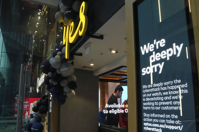 FILE - A customer waits for service at a Optus store in Sydney, Australia, Thursday, Oct. 7, 2021. (AP Photo/Mark Baker,File)