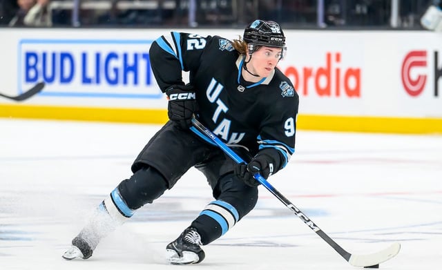 Utah Hockey Club center Logan Cooley (92) skates the puck during the third period of an NHL hockey game against the Winnipeg Jets, Saturday, April 5, 2025, in Salt Lake City.