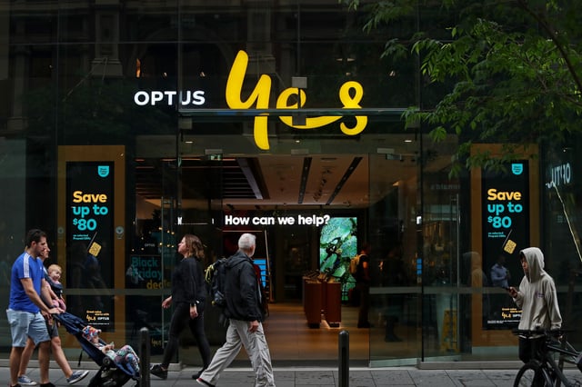 SYDNEY, AUSTRALIA - NOVEMBER 21: Pedestrians walk past an Optus store in the CBD on November 21, 2023 in Sydney, Australia. Optus' CEO Kelly Bayer Rosmarin stepped down on Monday after an extended outage last week caused millions of Australians to be disconnected from the network, with no access to emergency numbers for hours. The outage followed a hack that saw millions of customers' data shared online last year. (Photo by Lisa Maree Williams/Getty Images)