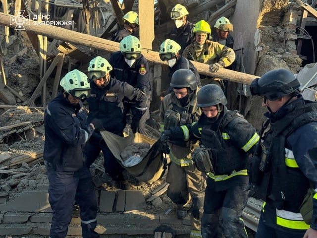 Rescuers carry the body of a woman found under debris of her house which was hit during a Russian air strike, amid Russia's attack on Ukraine, in Zaporizhzhia, Ukraine September 22, 2025. Press service of the State Emergency Service of Ukraine in Zaporizhzhia region/Handout via REUTERS