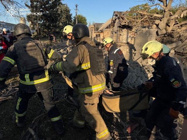 Rescuers carry the body of a woman found under debris of her house which was hit during a Russian air strike, amid Russia's attack on Ukraine, in Zaporizhzhia, Ukraine September 22, 2025. Press service of the State Emergency Service of Ukraine in Zaporizhzhia region/Handout via REUTERS
