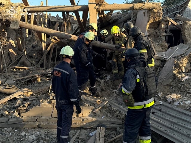 Rescuers carry the body of a woman found under debris of her house which was hit during a Russian air strike, amid Russia's attack on Ukraine, in Zaporizhzhia, Ukraine September 22, 2025. Press service of the State Emergency Service of Ukraine in Zaporizhzhia region/Handout via REUTERS