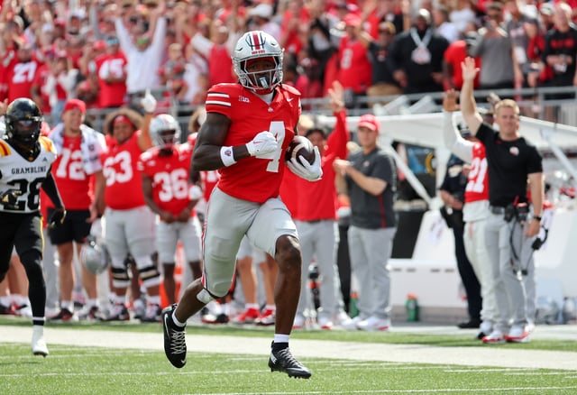 Sep 6, 2025; Columbus, Ohio, USA; Ohio State Buckeyes wide receiver Jeremiah Smith (4) scores a touchdown during the first quarter against the Grambling State Tigers at Ohio Stadium. Mandatory Credit: Joseph Maiorana-Imagn Images/File Photo