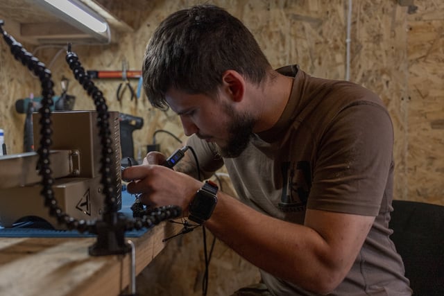 A Ukrainian serviceman known by the call sign "Miami" works on robotic military equipment near the front line in Donetsk region, Ukraine, on Monday, Sept. 8, 2025. (AP Photo/Alex Babenko)