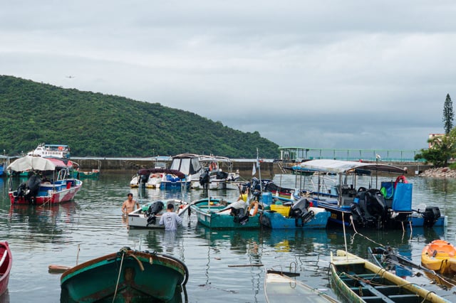 Local fishermen tied up their boats inside a boat haven before Typhoon Ragasa hits Hong Kong on September 21, 2025.