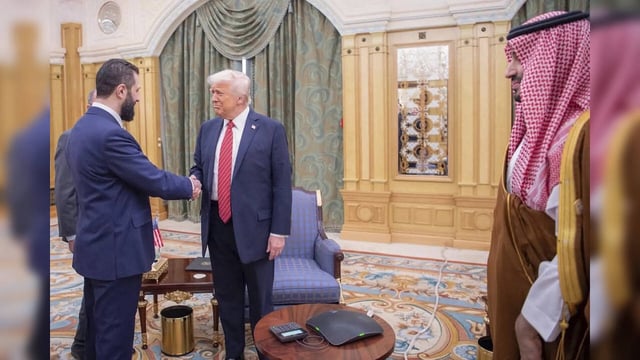 In this photo released by the Saudi Royal Palace, Syria's interim President Ahma...