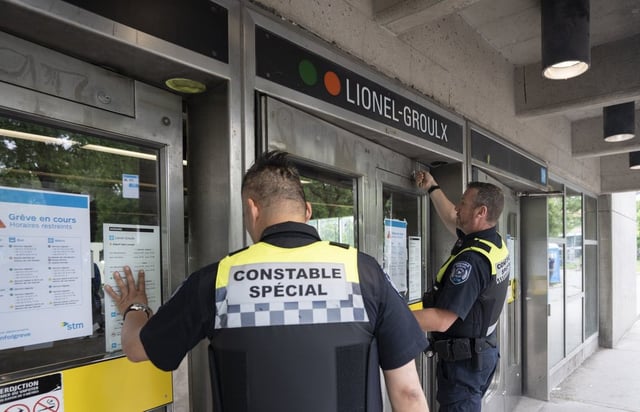 Special constables from the Montreal transit agency lock the doors to a subway station during a strike by maintenance workers in Montreal on Monday, June 9, 2025. THE CANADIAN PRESS/Christinne Muschi