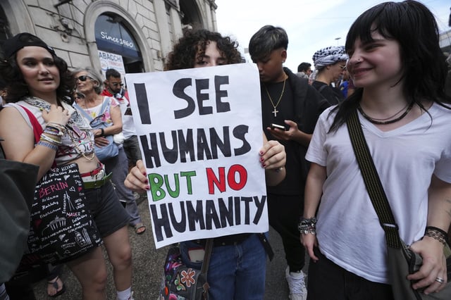 People hold banners as they participate at a demonstration part of a nation-wide protest and general strike against the war in Gaza, in Rome, Monday, Sept. 22, 2025. (AP Photo/Alessandra Tarantino)
