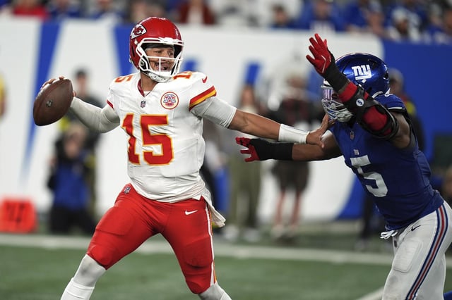 Patrick Mahomes throws as New York Giants outside linebacker Kayvon Thibodeaux chases him on Sunday.
