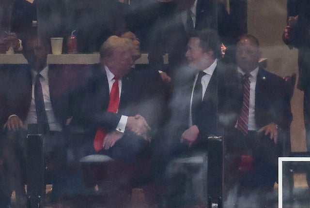 President Donald Trump and Tesla CEO Elon Musk shake hands during the public memorial service for right-wing activist Charlie Kirk at State Farm Stadium in Glendale, Arizona, on September 21, 2025.