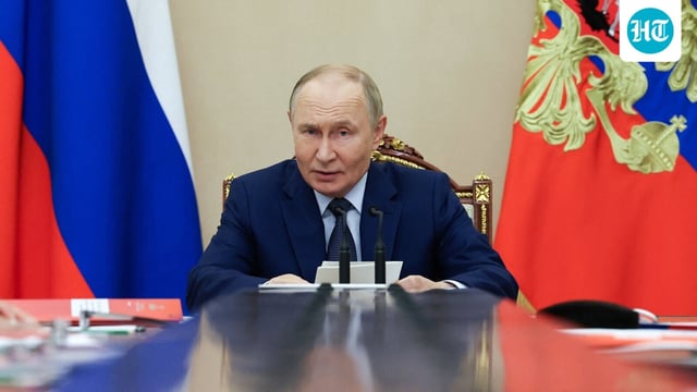 Russian President Vladimir Putin chairs a meeting with members of the Security Council at the Kremlin in Moscow.