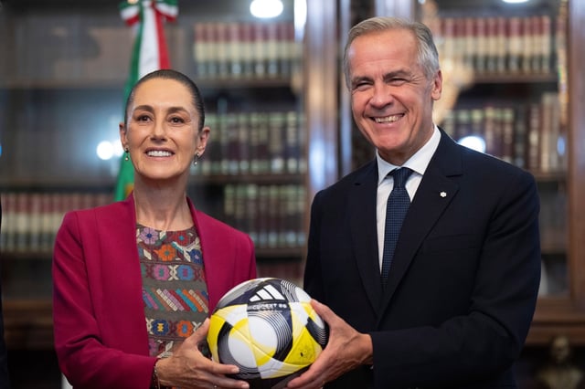 Canadian Prime Minister Mark Carney presents Mexican President Claudia Sheinbaum with a soccer ball at the Palacio National in Mexico City, Sep 18, 2025 (Canadian Press photo by Adrian Wyld via AP).