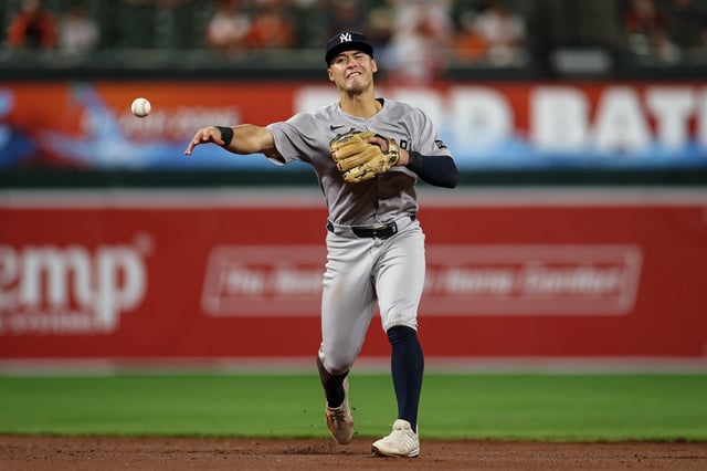 BALTIMORE, MD - SEPTEMBER 18: Anthony Volpe #11 of the New York Yankees throws to first base to retire Gunnar Henderson #2 of the Baltimore Orioles during the ninth inning at Oriole Park at Camden Yards on September 18, 2025 in Baltimore, Maryland. (Photo by Scott Taetsch/Getty Images)