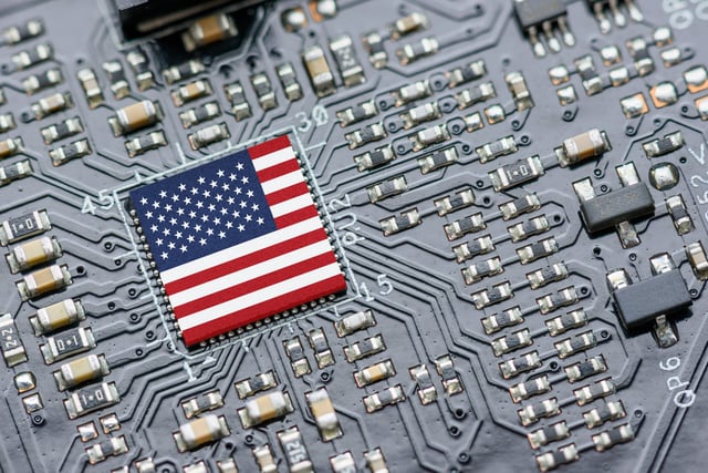 Flag of USA on a processor, CPU Central processing Unit or GPU microchip on a motherboard. US firms have become the latest collateral damage in US-China tech war. US blocks sales of AI chips to China.