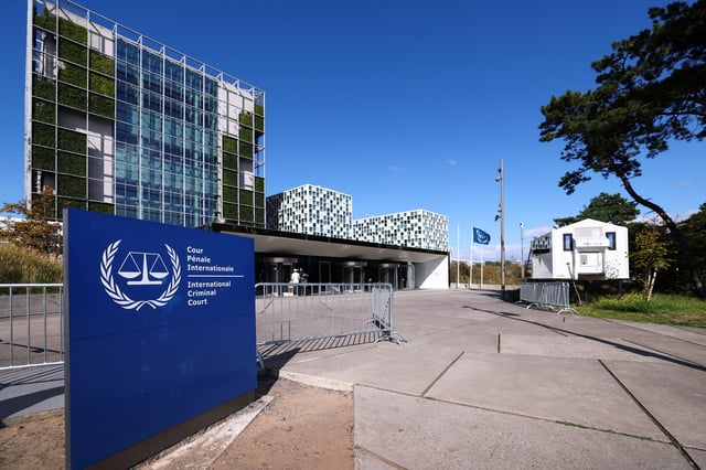 People stand outside the International Criminal Court (ICC) as the United States is considering imposing sanctions as soon as this week against the entire International Criminal Court, in The Hague, Netherlands, September 22, 2025. REUTERS/Piroschka van de Wouw