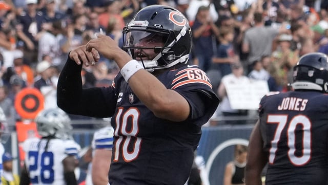 Sep 21, 2025; Chicago, Illinois, USA; Chicago Bears quarterback Caleb Williams (18) gestures after throwing a touchdown against the Dallas Cowboys during the second half at Soldier Field. Mandatory Credit: David Banks-Imagn Images