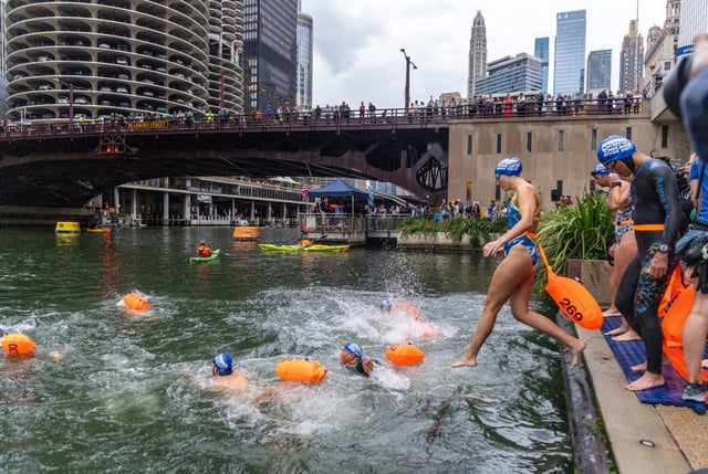 The second wave of 2-mile swimmers jump into the water before the Chicago River Swim, Sunday, Sept. 21, 2025, in Chicago. Over 300 swimmers gathered for the first organized swim in the Chicago River in 98 years. (Dominic Di Palermo/Chicago Tribune)
