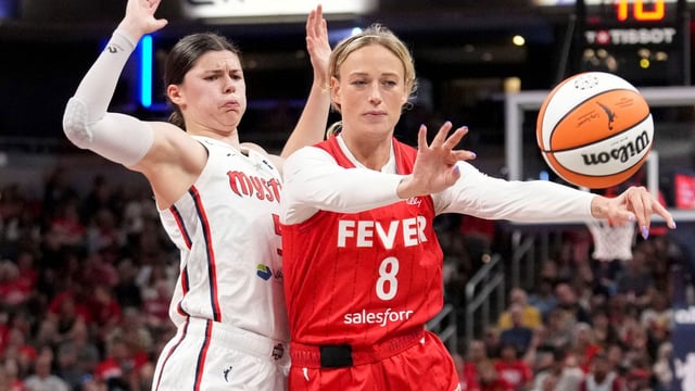 Washington Mystics guard Jade Melbourne (5) defends Indiana Fever guard Sophie Cunningham (8) as she looks to pass during the second half of a game Friday, Aug. 15, 2025, at Gainbridge Fieldhouse in Indianapolis. The Fever fell to the Mystics 88-84.