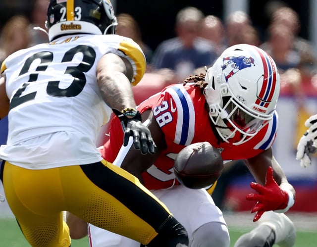 Foxboro, MA - New England Patriots running back Rhamondre Stevenson fumbles the ball during the first quarter of the game at Gillette Stadium. (Nancy Lane/Boston Herald)