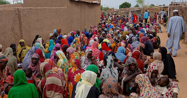 People line up for meals in El Fasher in August. Dozens were killed in a drone strike at a mosque in the city on Friday. AFP