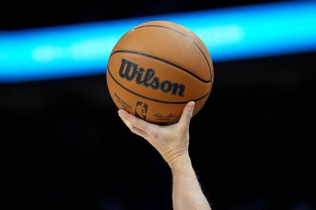 : A referee holds a Wilson brand official NBA game ball basketball during the game between the Detroit Pistons and Cleveland Cavaliers at Little Caesars Arena on March 28, 2025 in Detroit, Michigan.