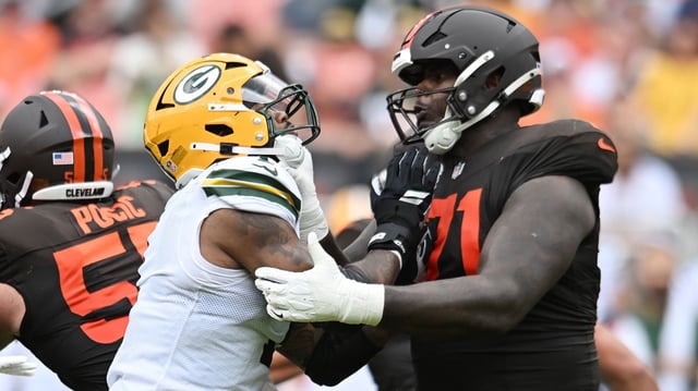Sep 21, 2025; Cleveland, Ohio, USA; Cleveland Browns offensive tackle Cornelius Lucas (71) blocks Green Bay Packers defensive end Micah Parsons (1) during the second half at Huntington Bank Field. Mandatory Credit: Ken Blaze-Imagn Images