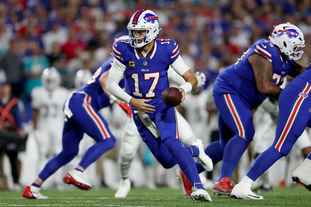 Josh Allen of the Buffalo Bills hands the ball to James Cook #4 (not pictured) in the first quarter of the game against the Miami Dolphins at Highmark Stadium on September 18, 2025 in Orchard Park, New York.