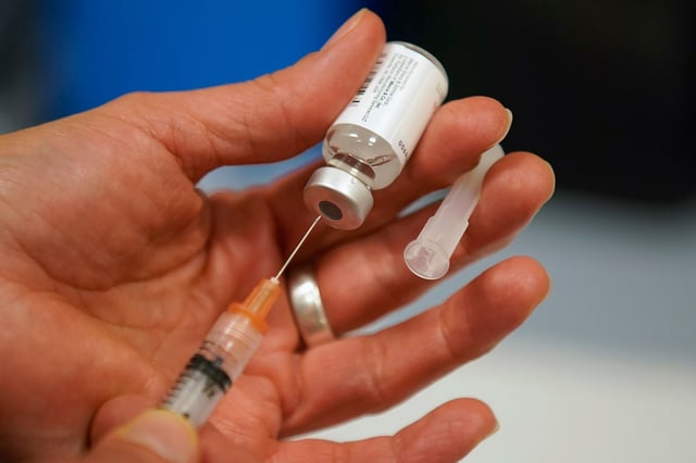 Sterile water is prepared for a one dose bottle of measles, mumps and rubella virus vaccine at the Salt Lake County Health Department on April 26, 2019.