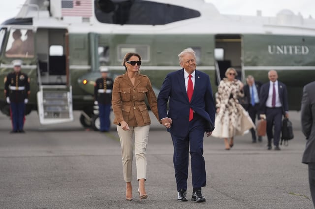 President Donald Trump and first lady Melania Trump walk after arriving on Marine One at Stansted Airport, Thursday, Sept. 18, 2025, in Stansted, England. (AP Photo/Evan Vucci)