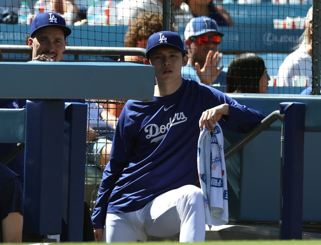 LOS ANGELES, CALIFORNIA - JULY 06: Rōki Sasaki #11 of the Los Angeles Dodgers with Blake Snell #7 watch from the dugout during the game between the Houston Astros and the Los Angeles Dodgers at Dodger Stadium on July 06, 2025 in Los Angeles, California.