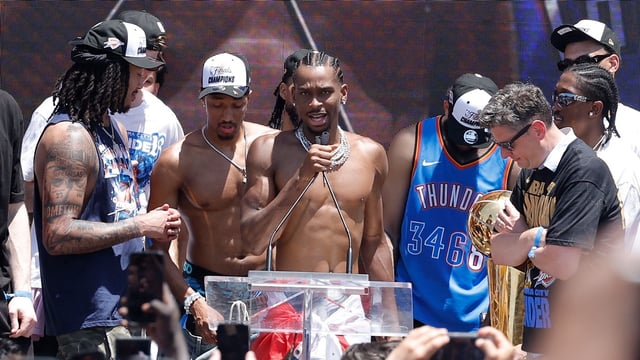 Thunder guard Shai Gilgeous-Alexander speaks to fans during the Oklahoma City Thunder Champions parade