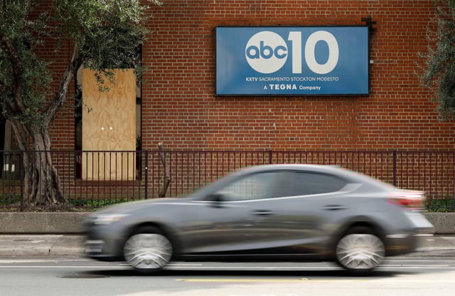 A window is was covered by a board after it was stuck by gunfire at ABC10 (KXTV) in Sacramento, Calif.,,on Sept. 19, 2025.  