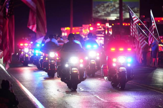 Police officers ride during a procession Wednesday, Sept. 17, 2025, in Spring Grove, Pa., after multiple police officers were shot and killed. (AP Photo/Matt Slocum)