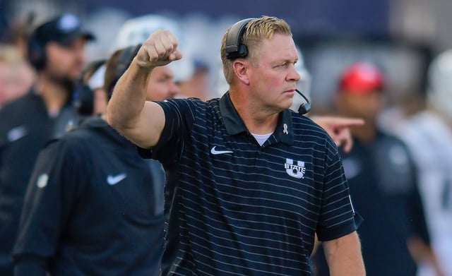 Utah State head coach Bronco Mendenhall celebrates after the Aggies got a first down against UTEP Saturday, Aug. 30, 2025, in Logan, Utah.