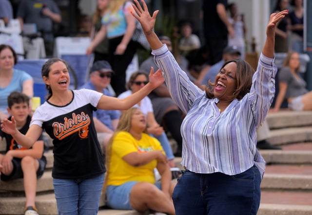 Jodi Guzewich (left) and Dianne Thomas, both Columbia residents dance to live music during 2023 Columbia Festival ‘s Lakefest Free Weekend at Lake Kittamaqundi’s Downtown Columbia Lakefront Friday June 16, 2023. (Karl Merton Ferron/Baltimore Sun Staff)