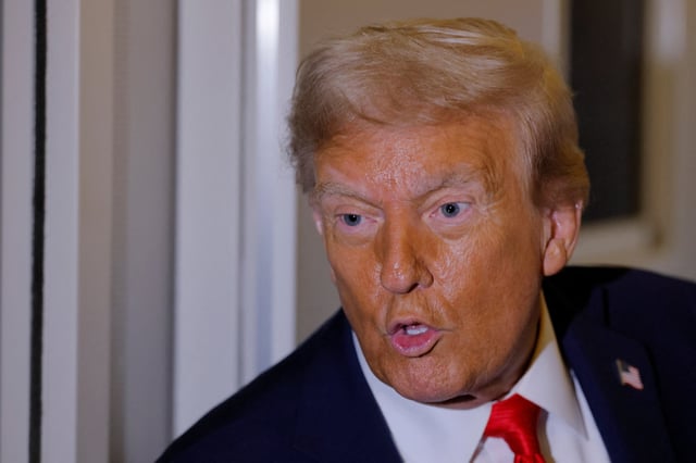 U.S. President Donald Trump answers a question from a reporter onboard Air Force One after attending the memorial service for slain conservative commentator Charlie Kirk, enroute to Joint Base Andrews, in Maryland, U.S. September 21, 2025. REUTERS/Brian Snyder/File Photo