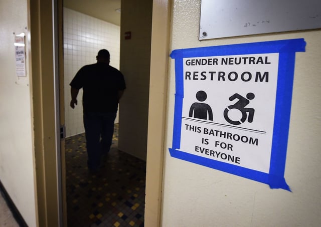 A sign posted outside a gender-neutral restroom at Santee High School in Los Angeles is shown in this file photo taken on May 4, 2016. (Mark Ralston / AFP/Getty Images)