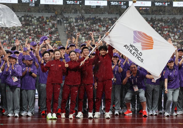 World Athletics Championships Tokyo 2025 - Japan National Stadium, Tokyo, Japan - September 21, 2025 Athletes from China are pictured holding the flag during the Handover Ceremony REUTERS/Kim Kyung-Hoon